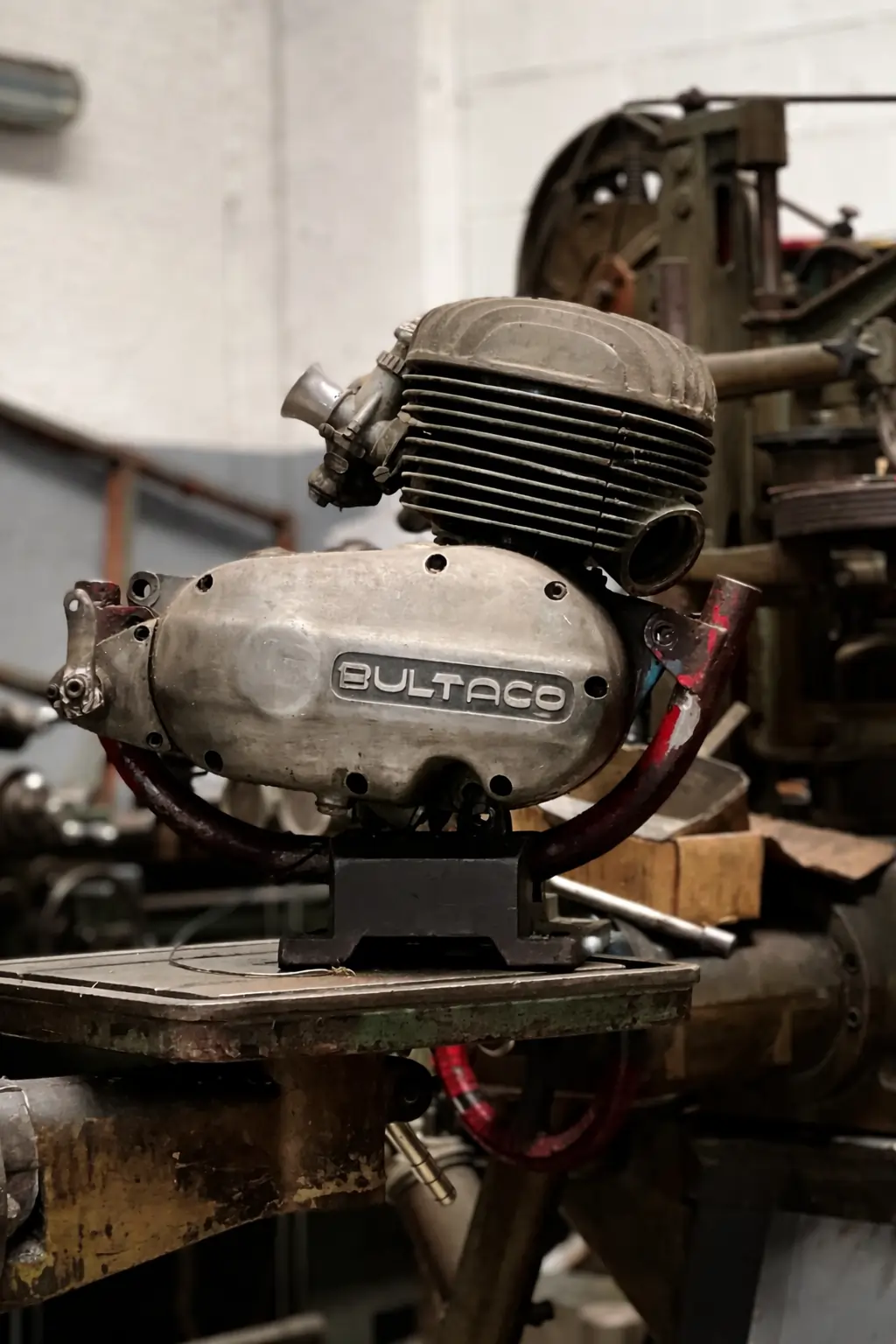 Mechanic working on vintage motorcycle engine restoration in Barcelona workshop